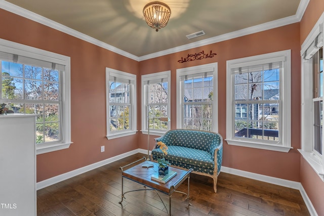 sitting room featuring hardwood / wood-style flooring, baseboards, and crown molding