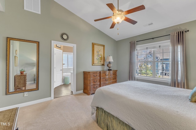 bedroom with light colored carpet, lofted ceiling, visible vents, and baseboards