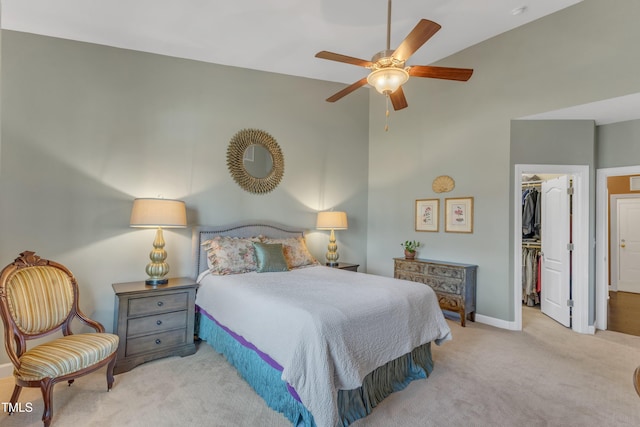 bedroom with baseboards, ceiling fan, a spacious closet, carpet floors, and a closet