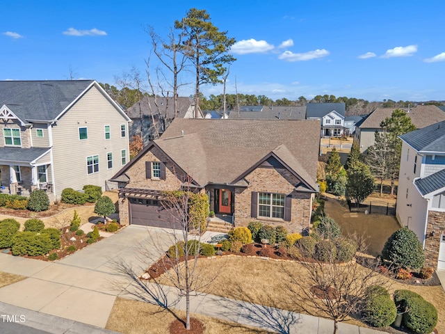 view of front of house with a shingled roof, a residential view, concrete driveway, and brick siding