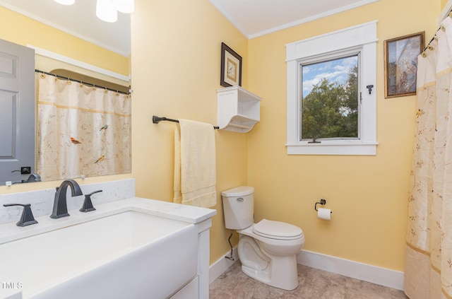 bathroom featuring tile patterned flooring, toilet, vanity, baseboards, and ornamental molding