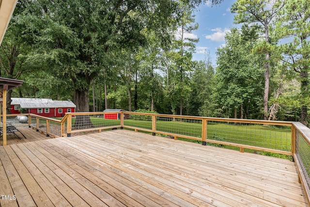 wooden deck featuring a lawn