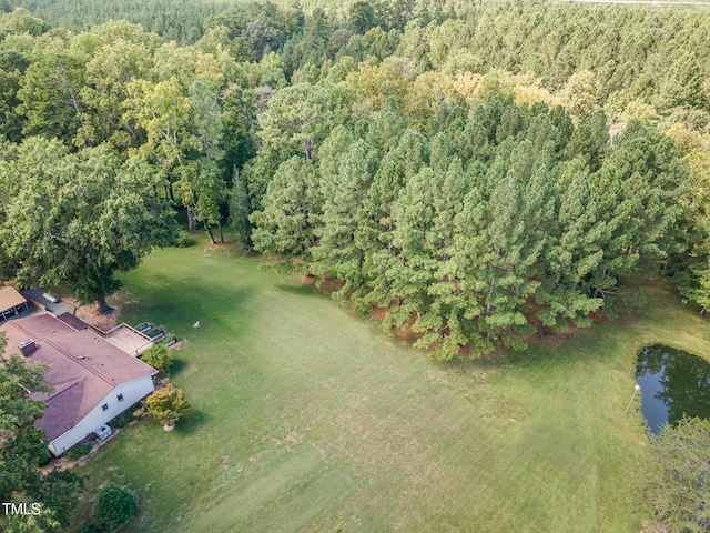 birds eye view of property with a water view and a wooded view