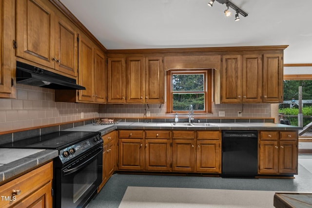 kitchen featuring decorative backsplash, brown cabinetry, a sink, under cabinet range hood, and black appliances