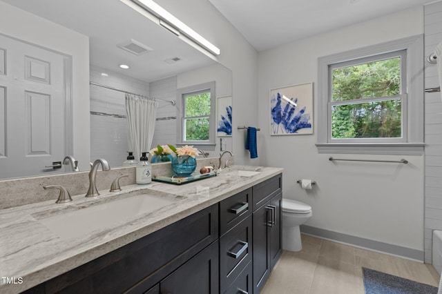 bathroom featuring toilet, a shower with curtain, and a sink