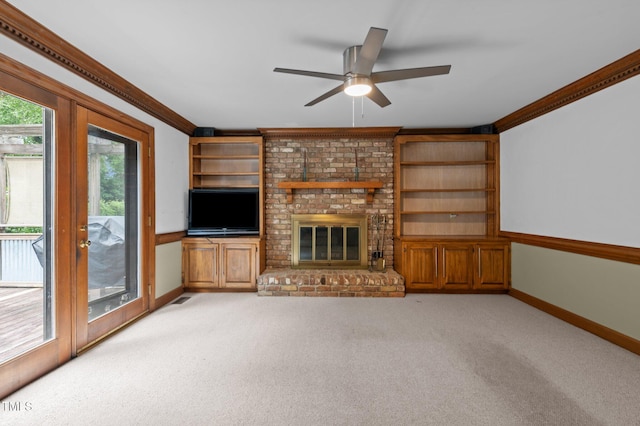 unfurnished living room featuring light carpet, baseboards, ceiling fan, ornamental molding, and a fireplace