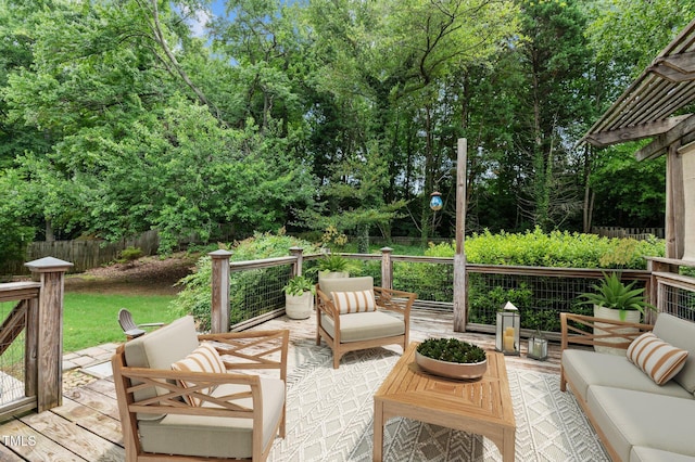 wooden terrace with fence and an outdoor hangout area