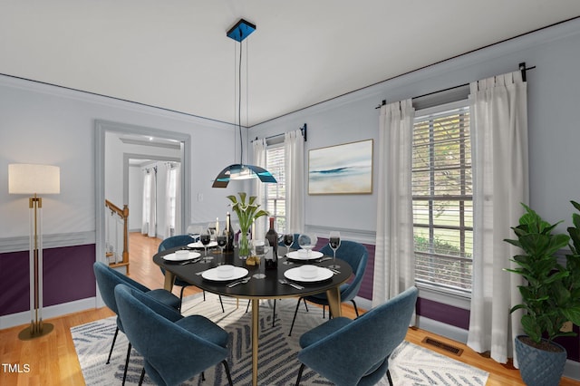 dining area featuring a healthy amount of sunlight, light wood-style floors, and visible vents