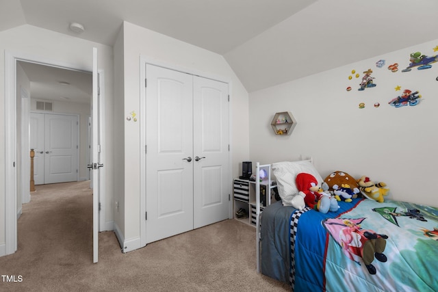 bedroom featuring light carpet, visible vents, vaulted ceiling, and a closet