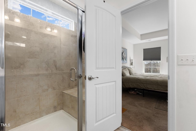 ensuite bathroom featuring ensuite bath and a shower stall