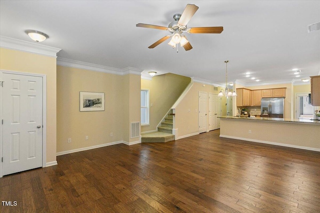 unfurnished living room featuring crown molding, dark wood finished floors, ceiling fan, and stairs