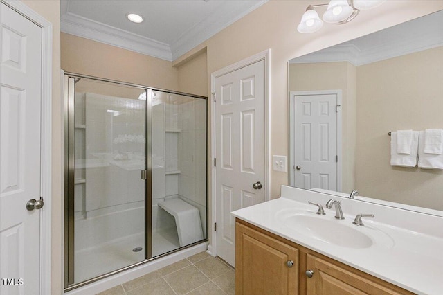 bathroom with a shower stall, vanity, ornamental molding, and tile patterned floors