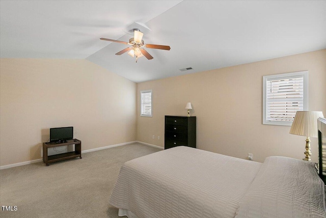 bedroom with light carpet, vaulted ceiling, baseboards, and ceiling fan