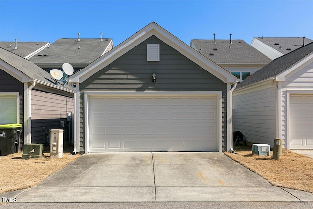 garage featuring concrete driveway