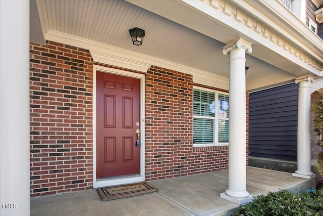 property entrance featuring brick siding