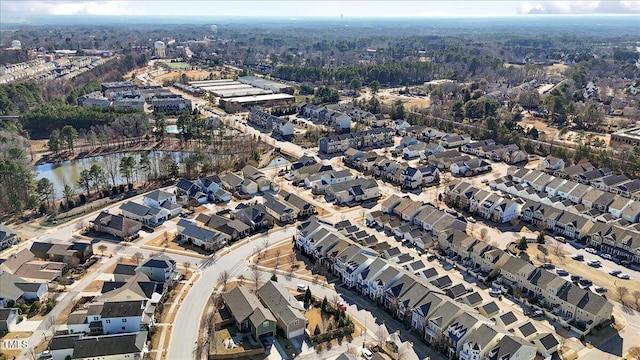 drone / aerial view with a residential view and a water view