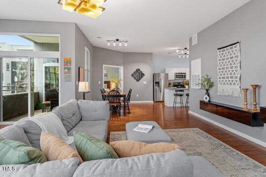 living area featuring baseboards and wood finished floors