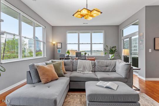 living room with baseboards and light wood-style floors