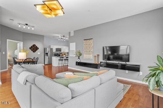 living area with baseboards and light wood-style floors