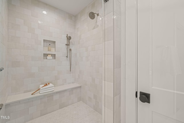 full bathroom featuring a tile shower