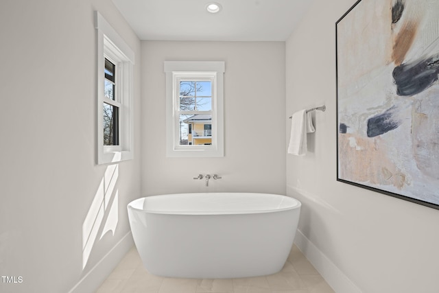 full bath with tile patterned flooring, a soaking tub, recessed lighting, and baseboards