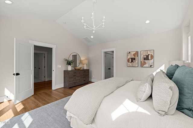 bedroom with visible vents, lofted ceiling, recessed lighting, wood finished floors, and a notable chandelier