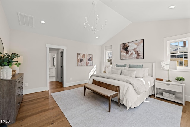 bedroom with visible vents, multiple windows, lofted ceiling, and wood finished floors