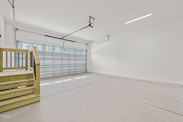 garage with baseboards and a garage door opener