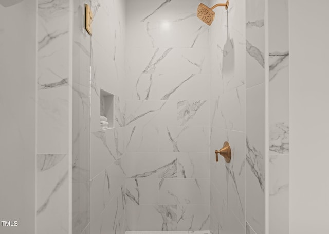 bathroom with a marble finish shower