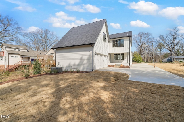 view of home's exterior featuring central air condition unit, a yard, roof with shingles, concrete driveway, and an attached garage