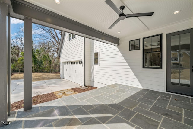 view of patio / terrace with ceiling fan and driveway