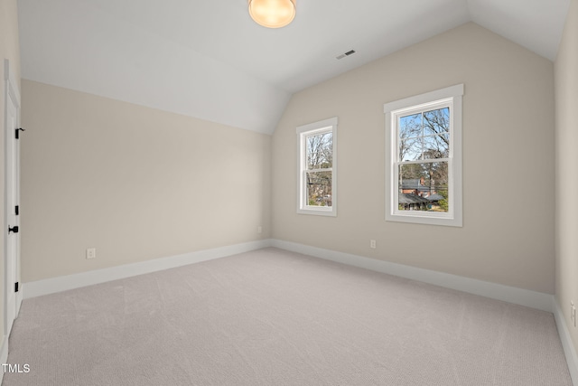 bonus room featuring visible vents, light colored carpet, baseboards, and lofted ceiling