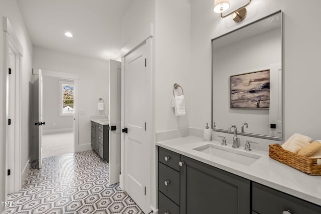 bathroom featuring recessed lighting, baseboards, and vanity