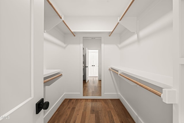 walk in closet featuring dark wood-style flooring