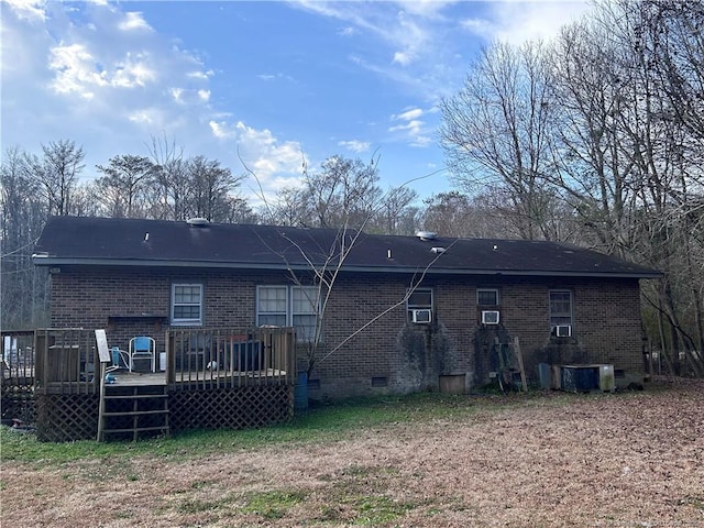 back of property featuring cooling unit, crawl space, brick siding, and a wooden deck