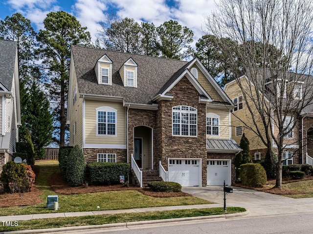 split foyer home with an attached garage, driveway, roof with shingles, and stone siding