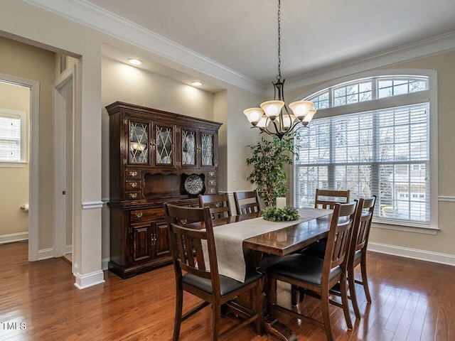 dining room with baseboards, an inviting chandelier, dark wood finished floors, and crown molding