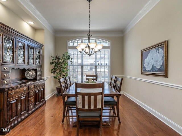 dining space featuring a notable chandelier, dark wood-style flooring, baseboards, and crown molding