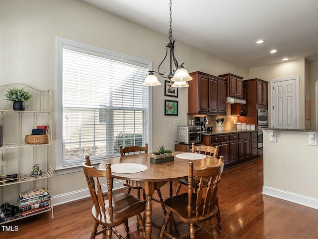 dining area featuring recessed lighting, dark wood-style flooring, a toaster, and baseboards