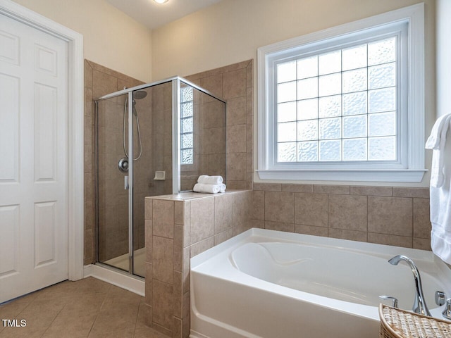 full bathroom with a stall shower, tile patterned flooring, and a garden tub