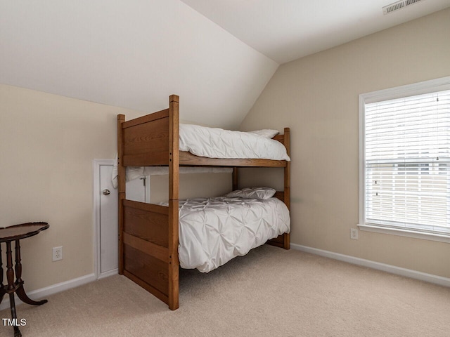 bedroom featuring light carpet, vaulted ceiling, visible vents, and baseboards