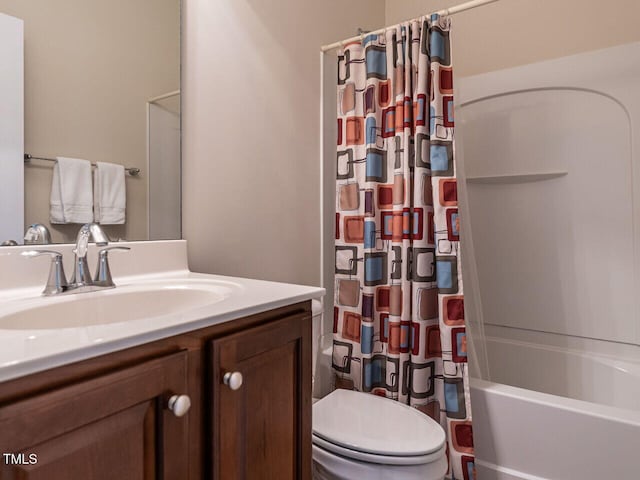 full bath featuring shower / bath combo with shower curtain, vanity, and toilet