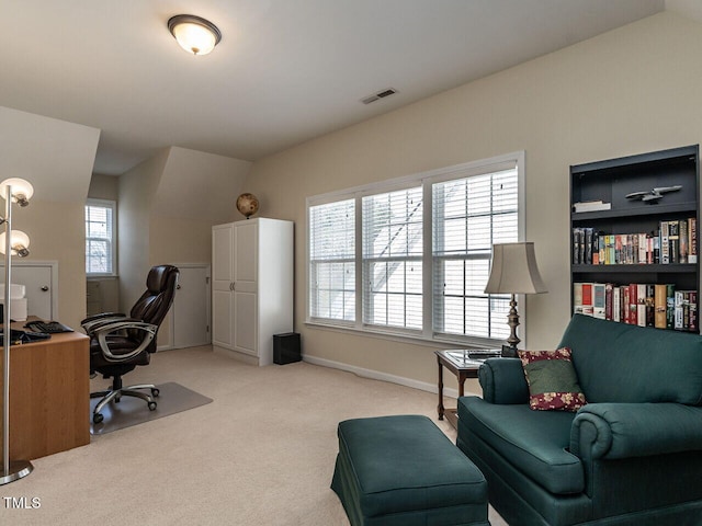 office space featuring light carpet, baseboards, and visible vents