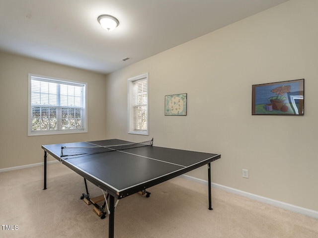 recreation room with carpet floors, visible vents, and baseboards