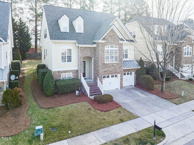 raised ranch with roof with shingles, a front yard, a garage, stone siding, and driveway