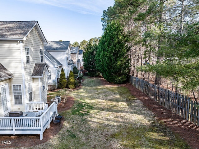 view of yard with fence and a wooden deck