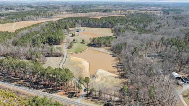 birds eye view of property featuring a water view and a view of trees