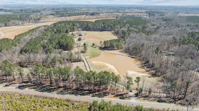 birds eye view of property with a water view and a view of trees