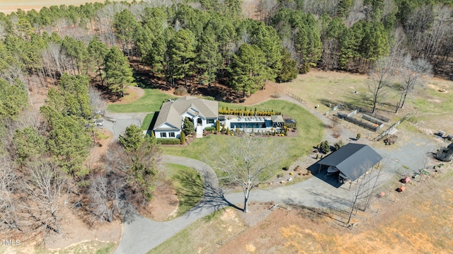 bird's eye view featuring a wooded view