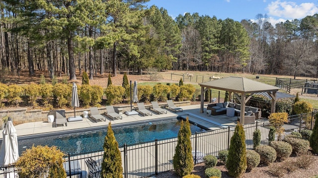 pool featuring a patio area, outdoor lounge area, and fence